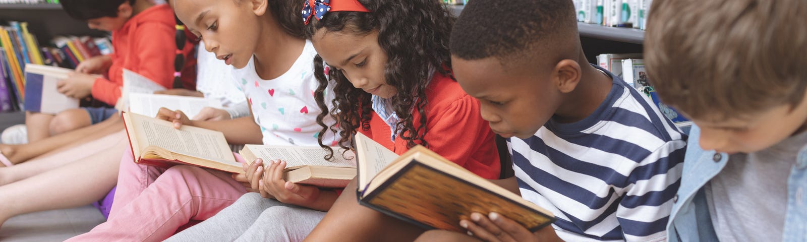 Summer Reading Photo: A group of children reading books at the library