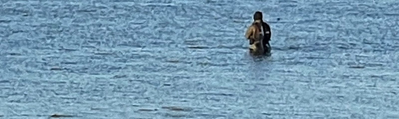 A fisherman in Portsmouth Harbour at low water (source: author)