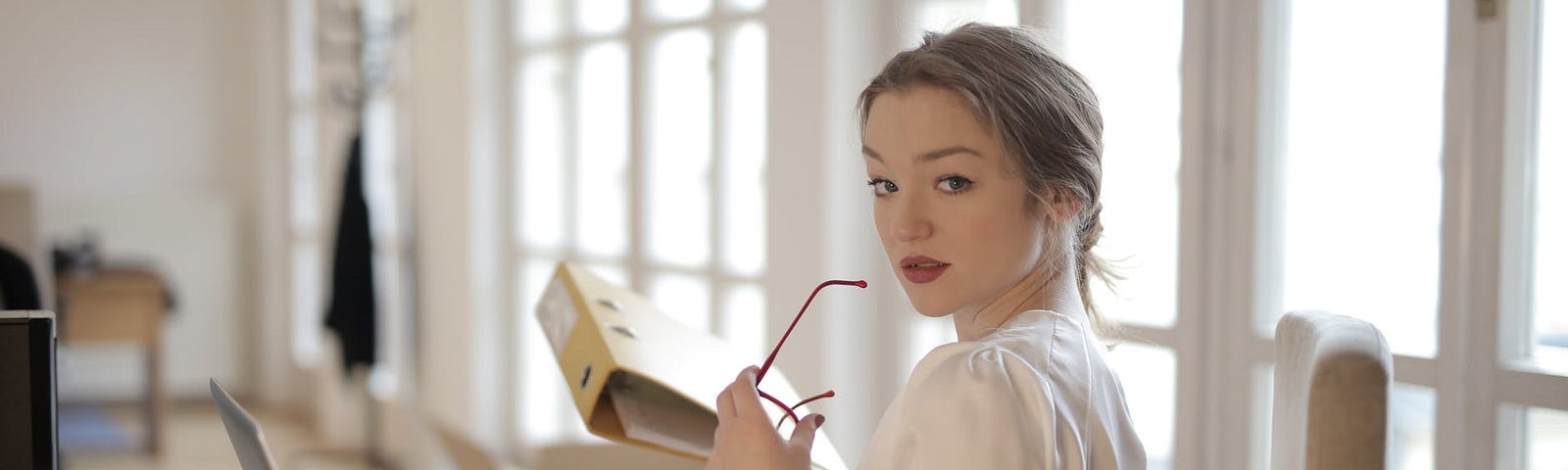 Elegant woman using her laptop while picking the best habit for her