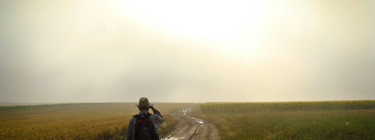 A man walking down a country road