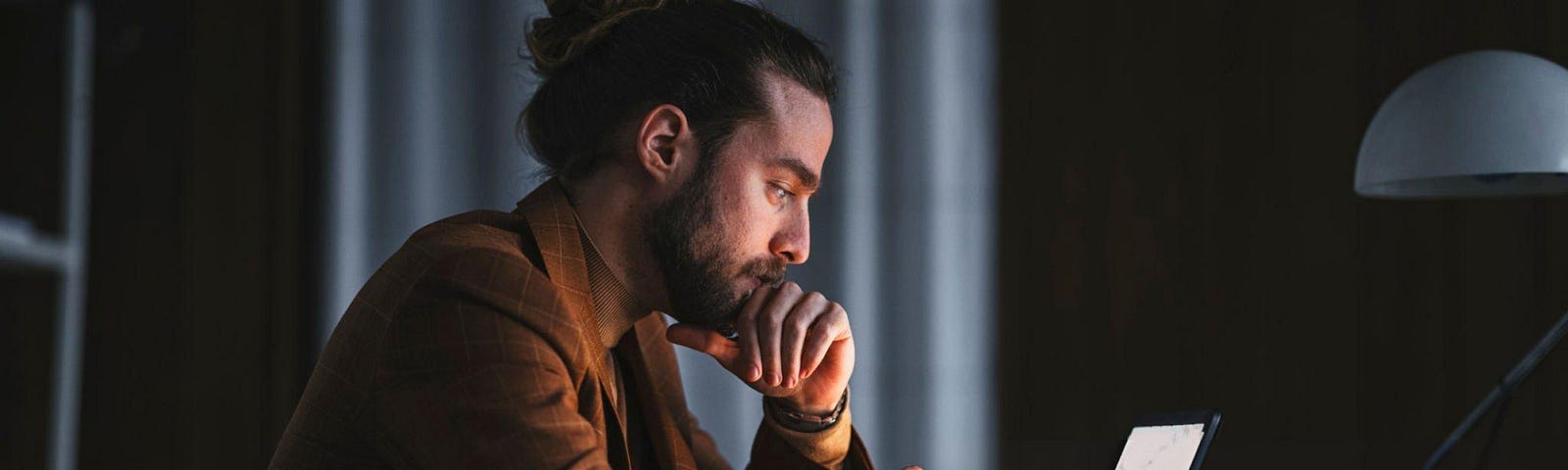 Man infront of laptop looking devastated