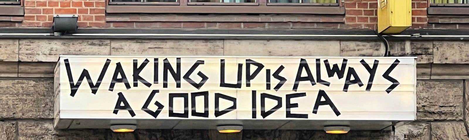 Sign on the Berlin Michelberger Hotel Building stating „Waking up is always a good idea“