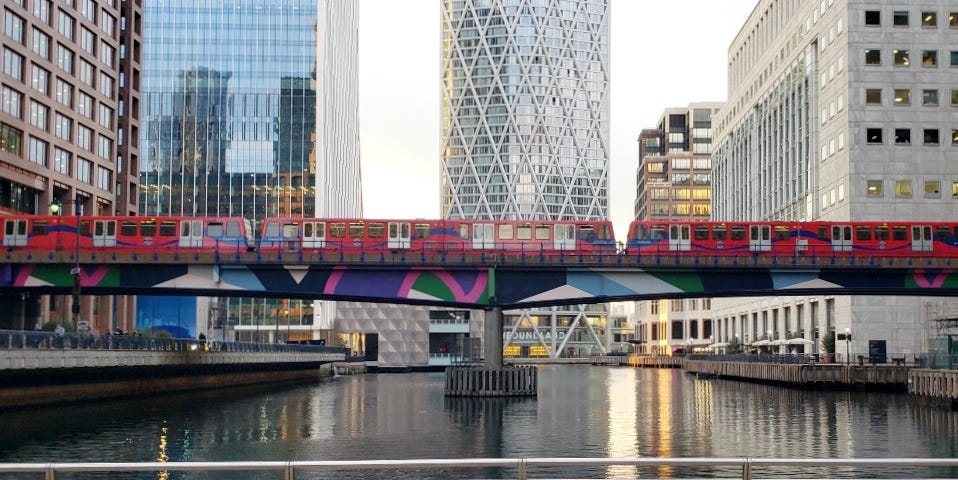 A train crosses a dock in Canary Wharf