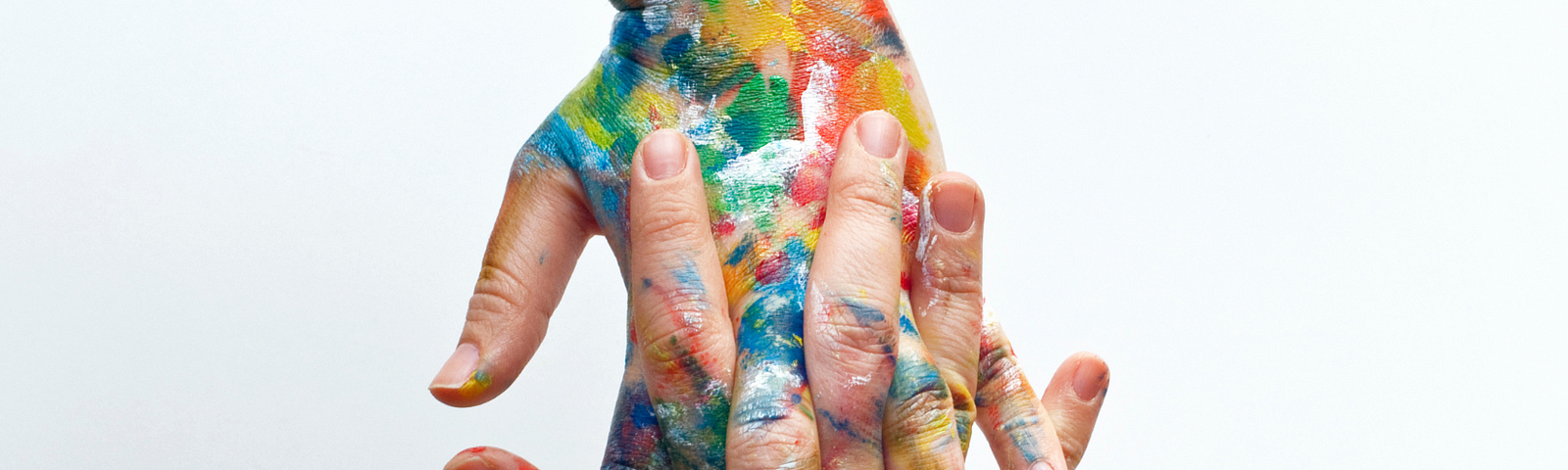 Two paint-covered hands interlaced; Alt-text for “How to Build a Substack”
