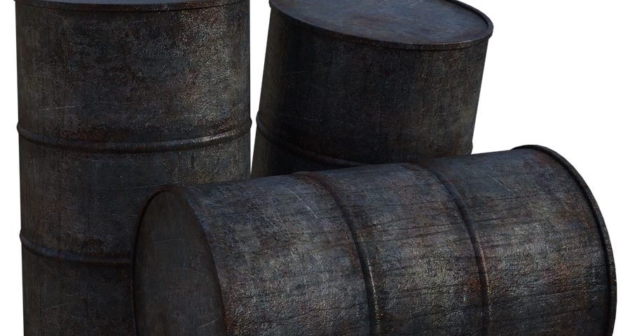 IMAGE: Three old, black and dirty oil barrels