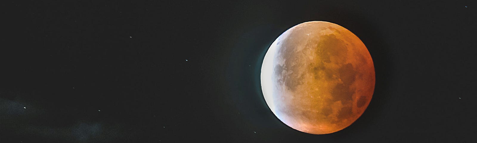 Moon rising in the sky at night.