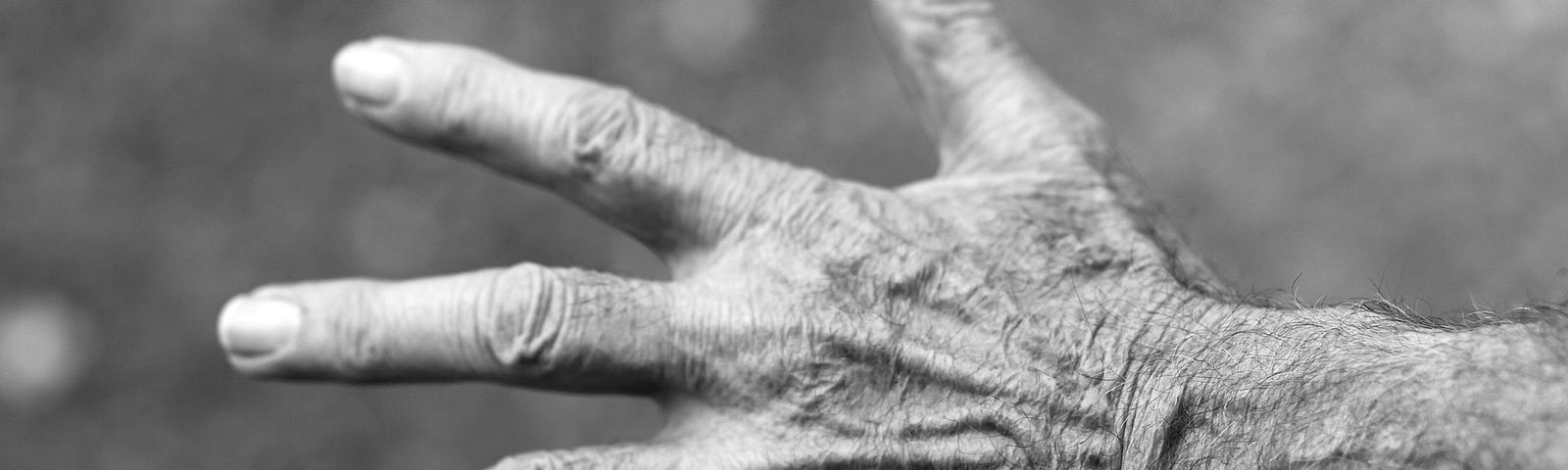 Black and white photo of an elderly woman’s hand.