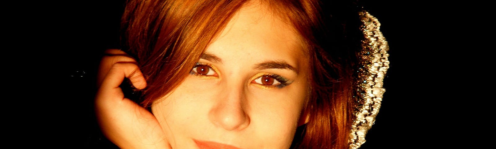 portrait of pretty young woman with a closed mouth smile and long brown hair