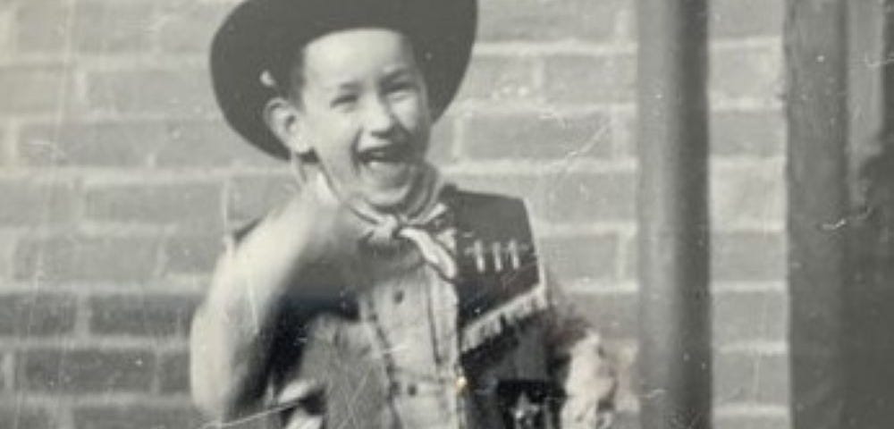 The author in his cowboy suit — hat, scarf, waistcoat, two guns and chaps