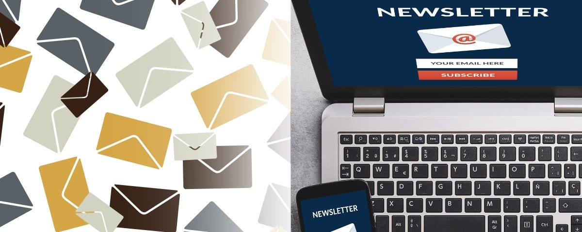 A bunch of envelopes scattered next to an open laptop and phone screen with a newsletter on it