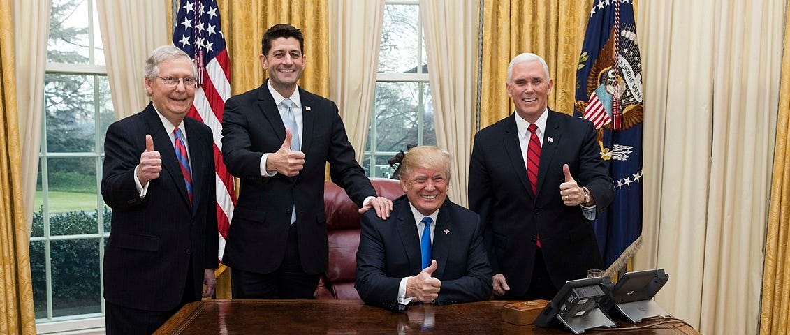 President Trump, Vice President Pence, Senator McConnell and Representative Ryan display “thumbs up” after a bill signing in the Oval Office.