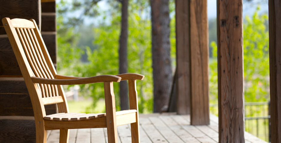 wooden rocking chair on wooden deck in the woods