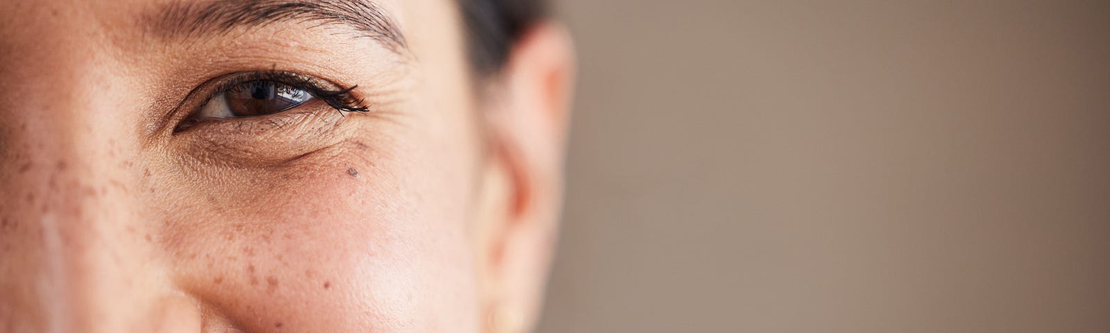 Closeup of a young Asian woman smiling.