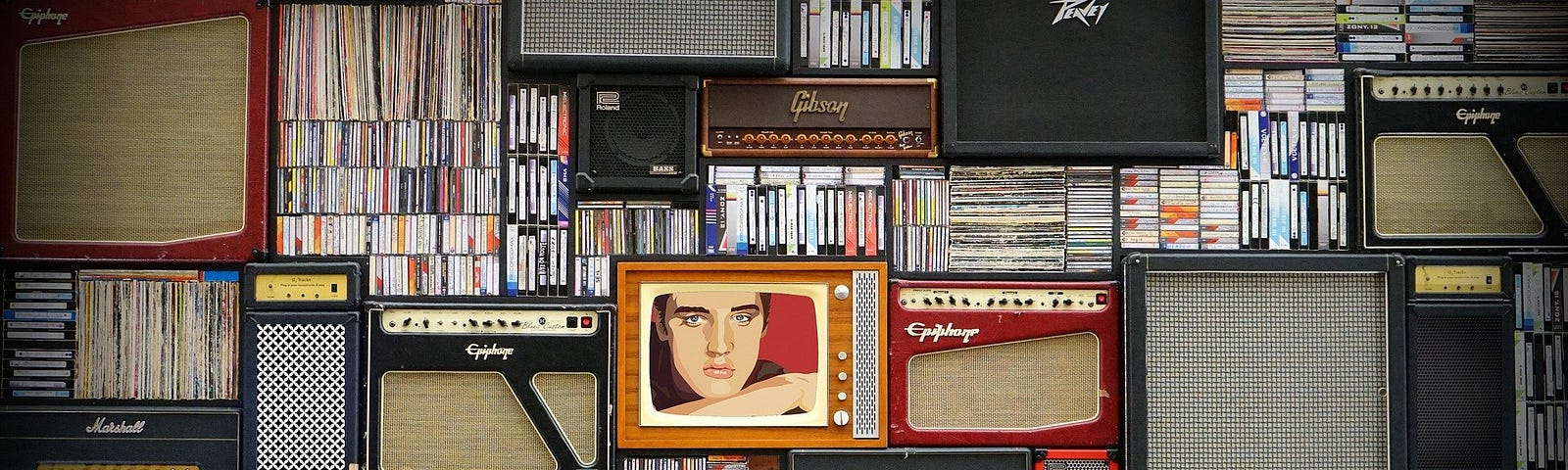 Old amplifiers, televisions and records. One of the televisions has an image of Elvis Presley on it.