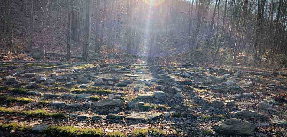 A labyrinth in the woods at sunrise at sticks and stones farm in newtown, ct.