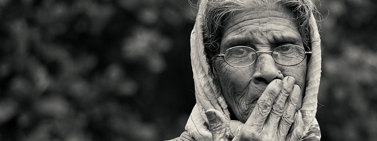 A photo of an old lady taken in black and white.