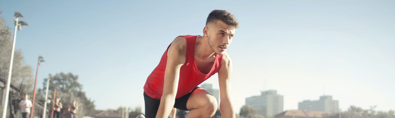 man at the starting line of a race track