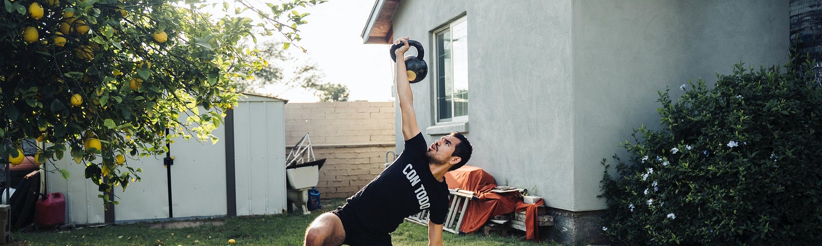 Man working out with kettlebells at home.