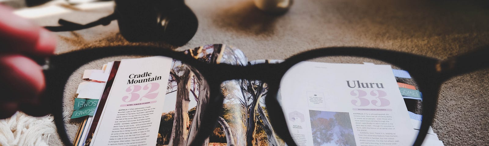 Looking through glasses at an open magazine