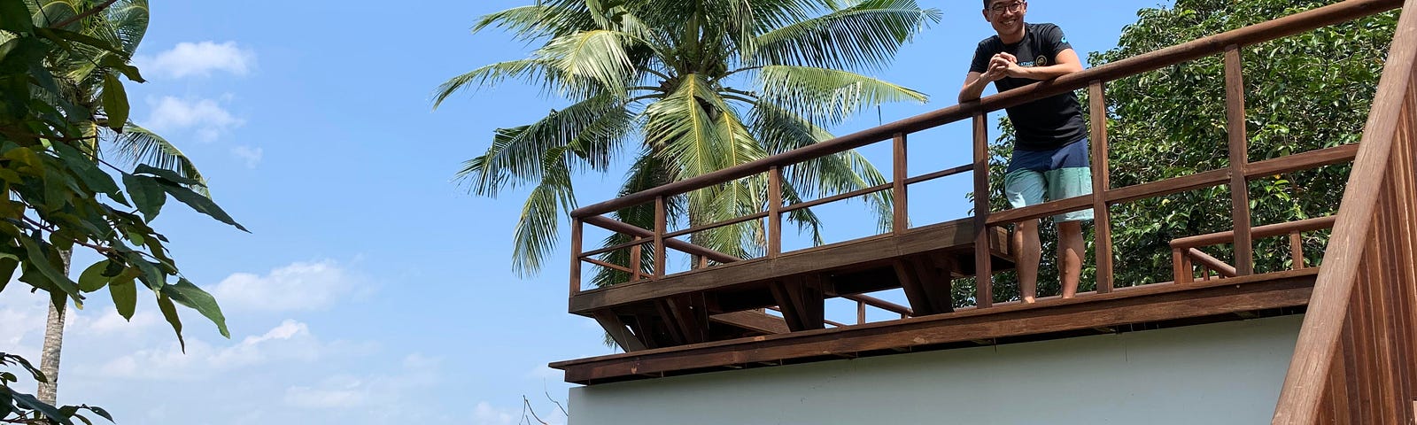 Author standing at the balcony of a beach resort.