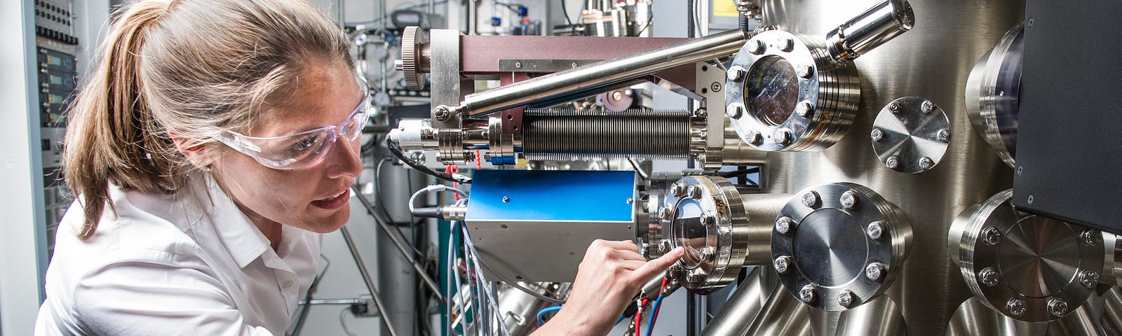 Scientist wearing safety glasses working in a solar energy research facility.