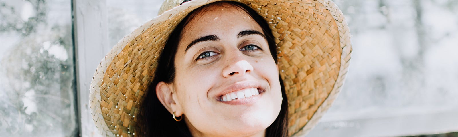 Smiling woman with sunhat.