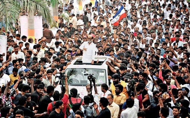 Image showing Rajinikanth waving at the gathering of a huge crowd