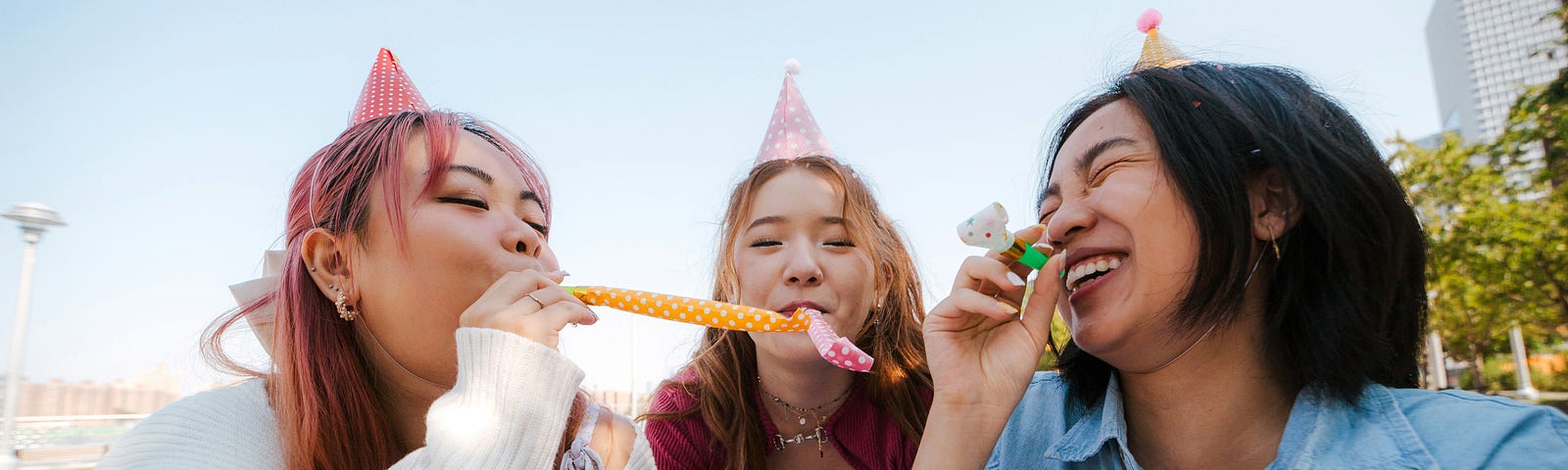 3 women with birthday hats on