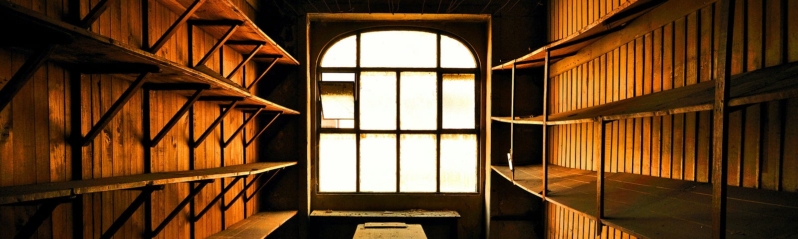 Empty shelves, and empty bench, a glowing window. The Empty Cupboard Jim Latham