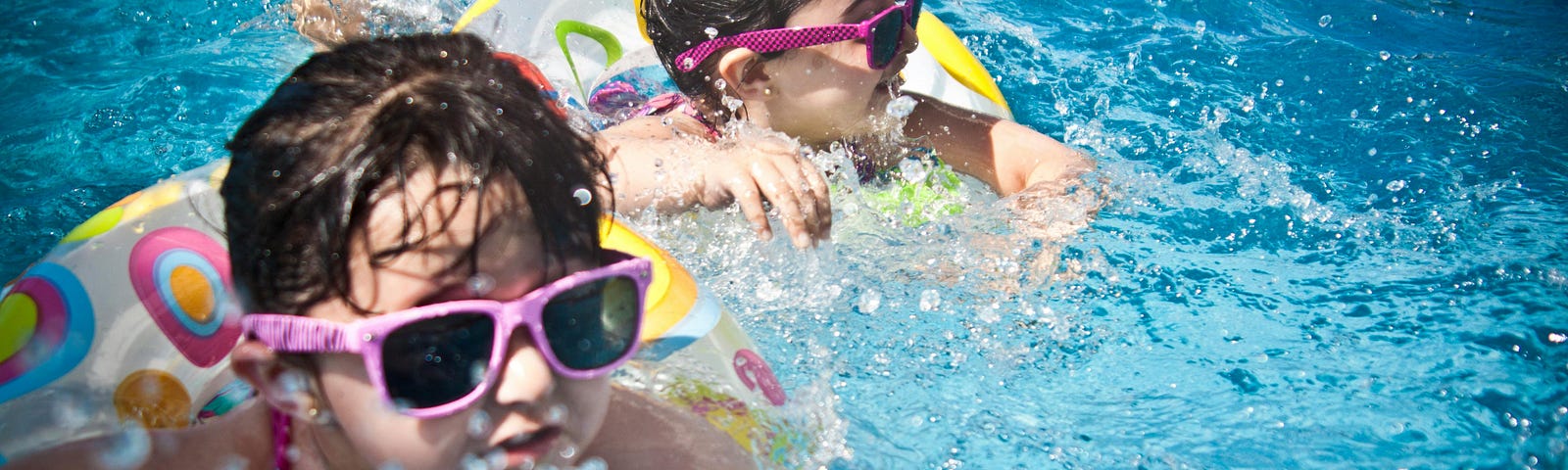 This shows two girls swimming in a pool.