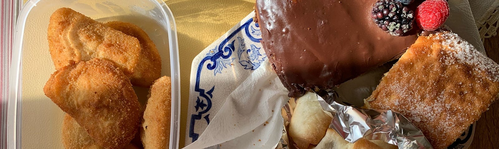 A variety of homemade Portuguese cakes and salty treats on a table