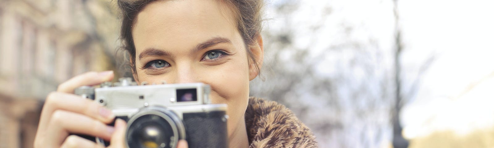 Woman holding black and gray focus camera