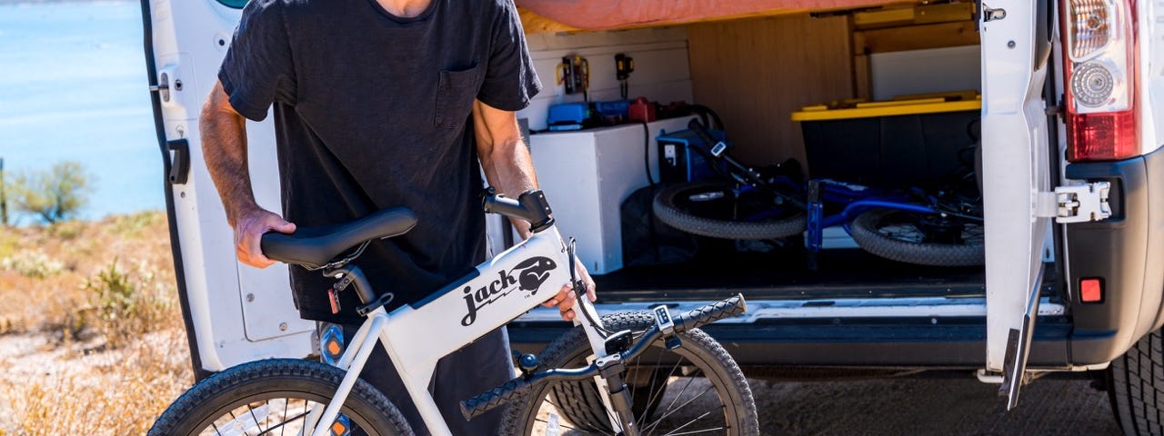 A view of a white Jackrabbit being unloaded from a vehicle in time for a ride.