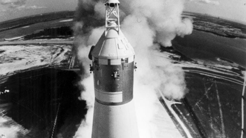 Black and white photo of the liftoff of Apollo 11