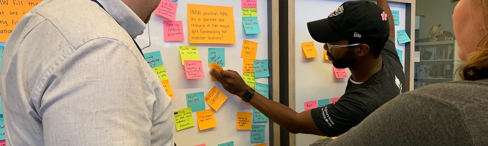 Lab team members reviewing sticky notes full of ideas after a brainstorming session