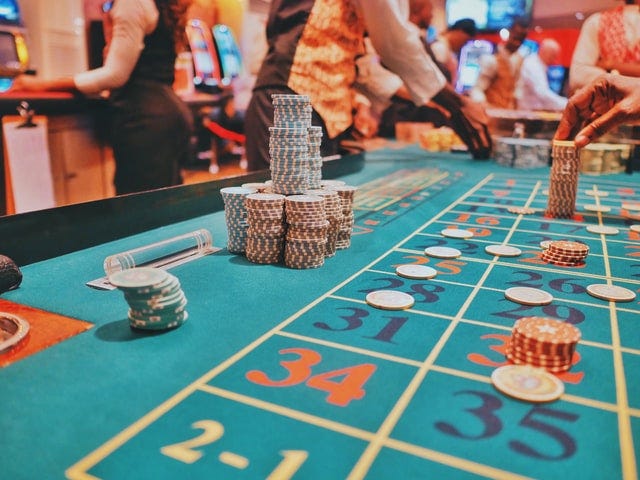 Stacks of chips on a roulette table inside a casino.