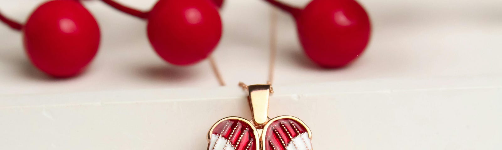 heart shaped locket in front of berry branch