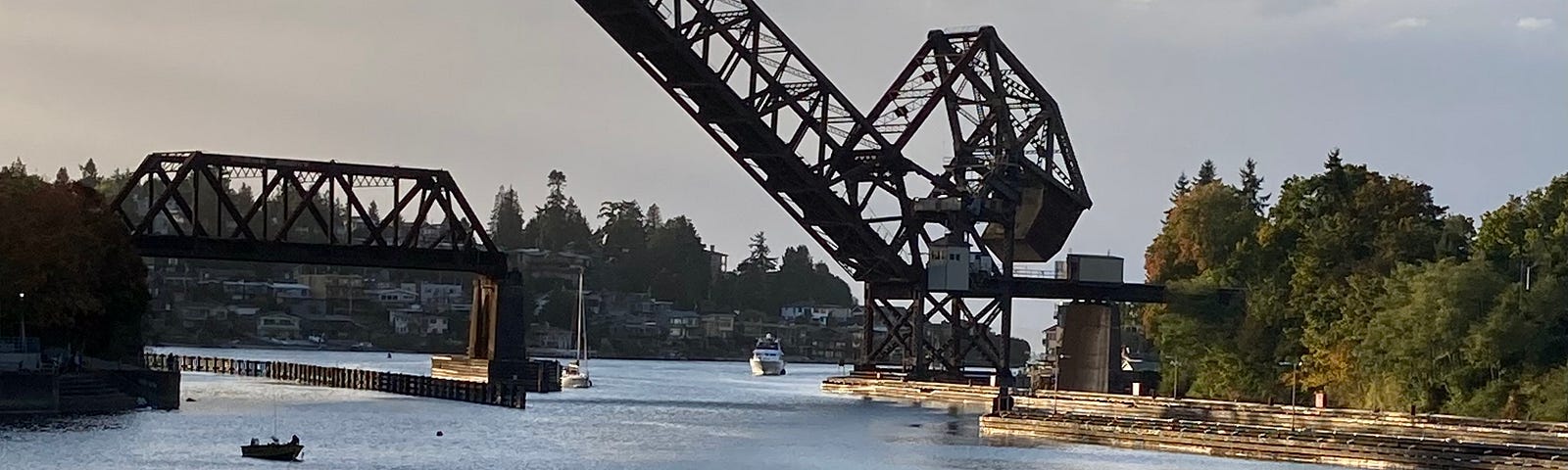 an image of the salt water leading into the Ballard Locks with the Salmon Bay Bridge in the background