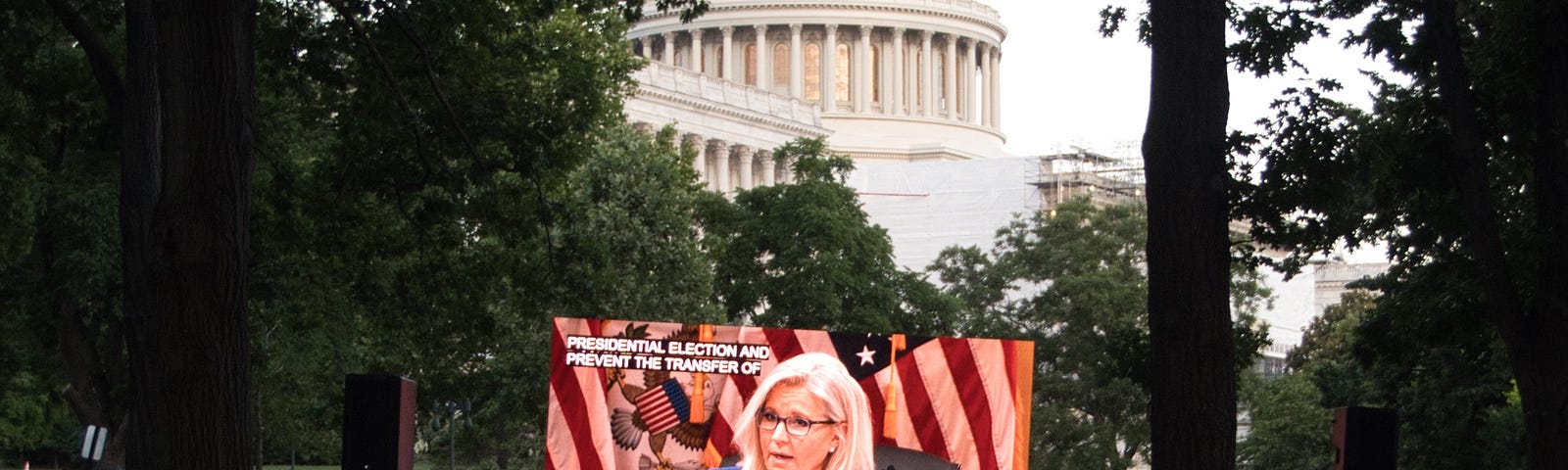 A crowd of people gathers near the U.S. Capitol to watch the first hearing of the January 6 committee on June 9, 2022.