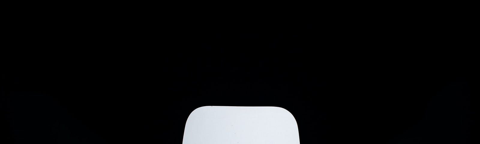 White chair on black background