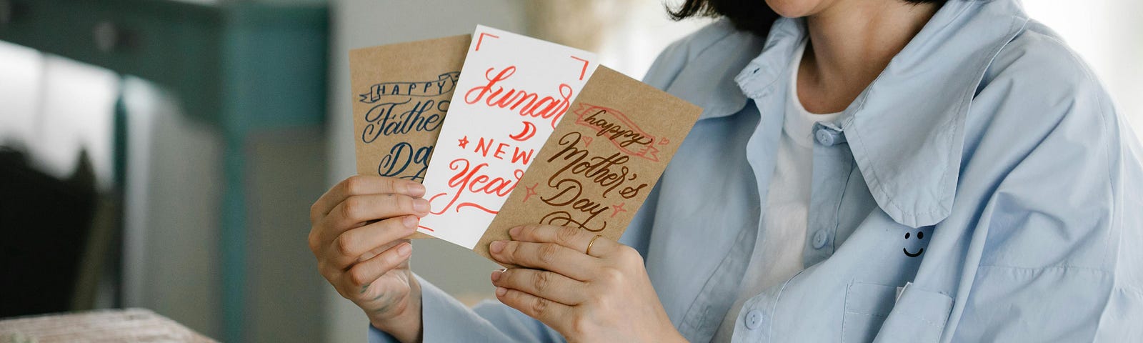 A Woman Holding Assorted Greeting Cards