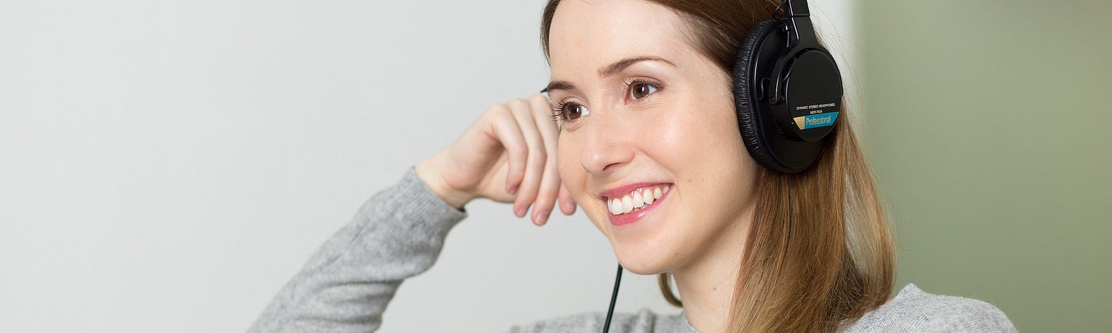 A woman listening to music on her headphones