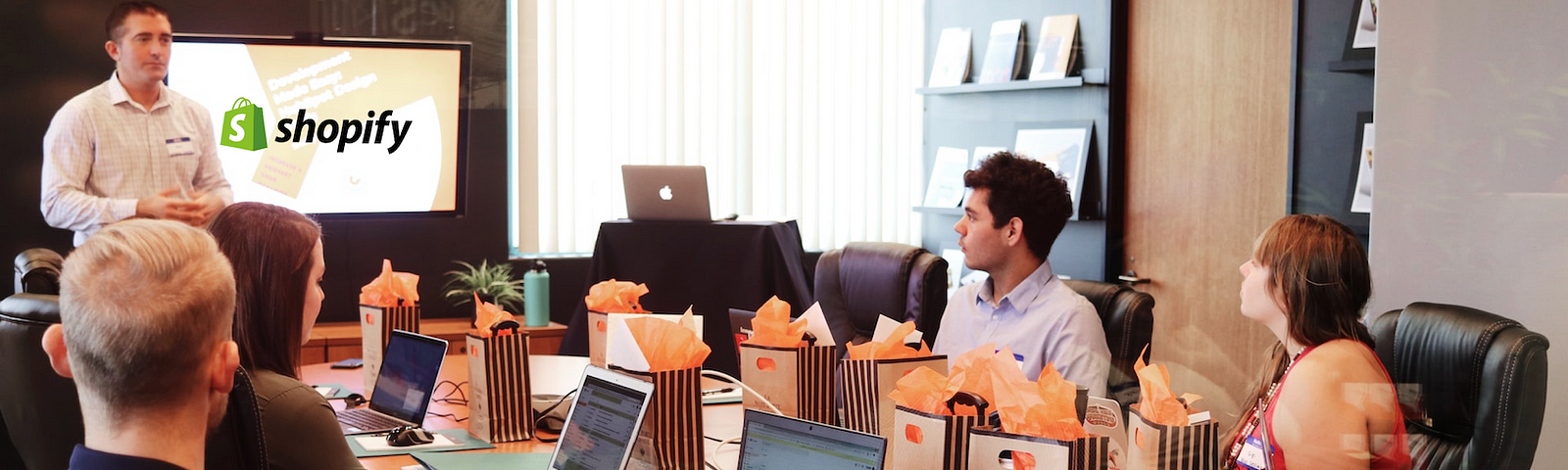 IMAGE: A business meeting with six people with their laptops open