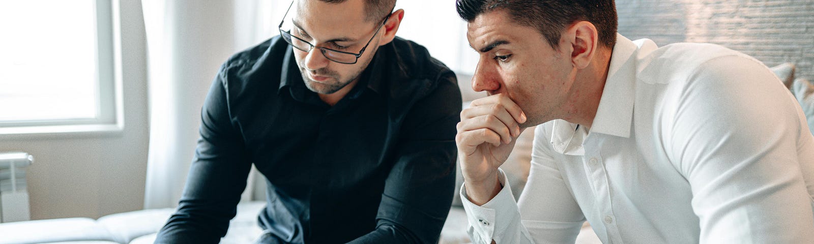 Two Men Discussing Graph on iPad