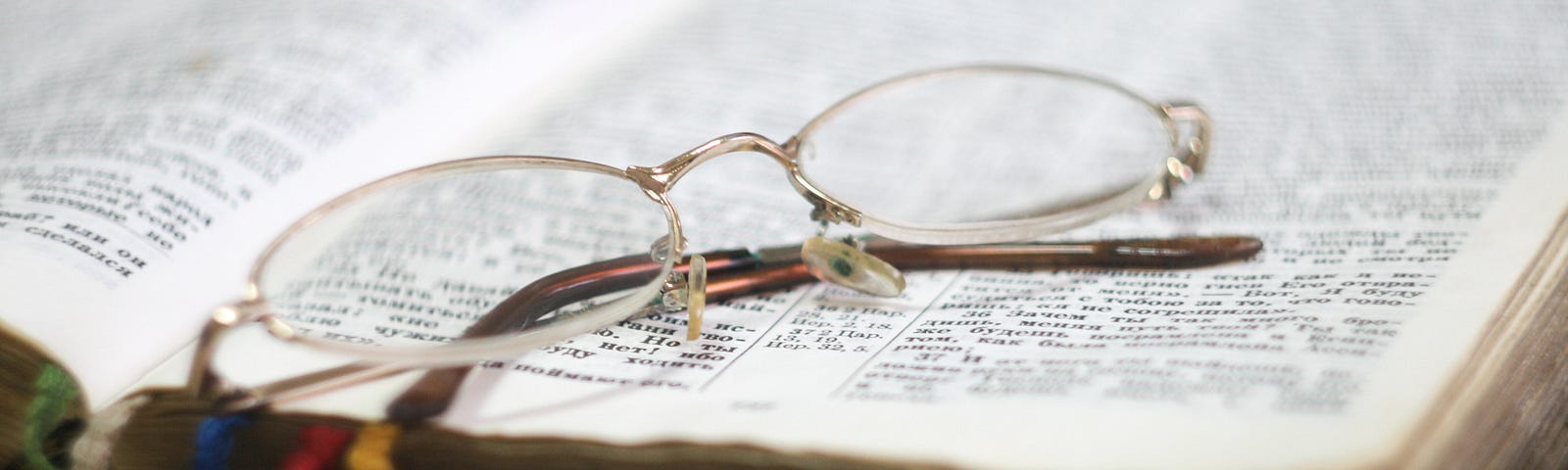 open bible with glasses on top