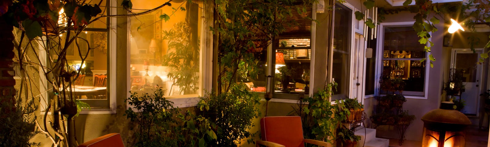 An evening Patio with a glowing warm light from the window