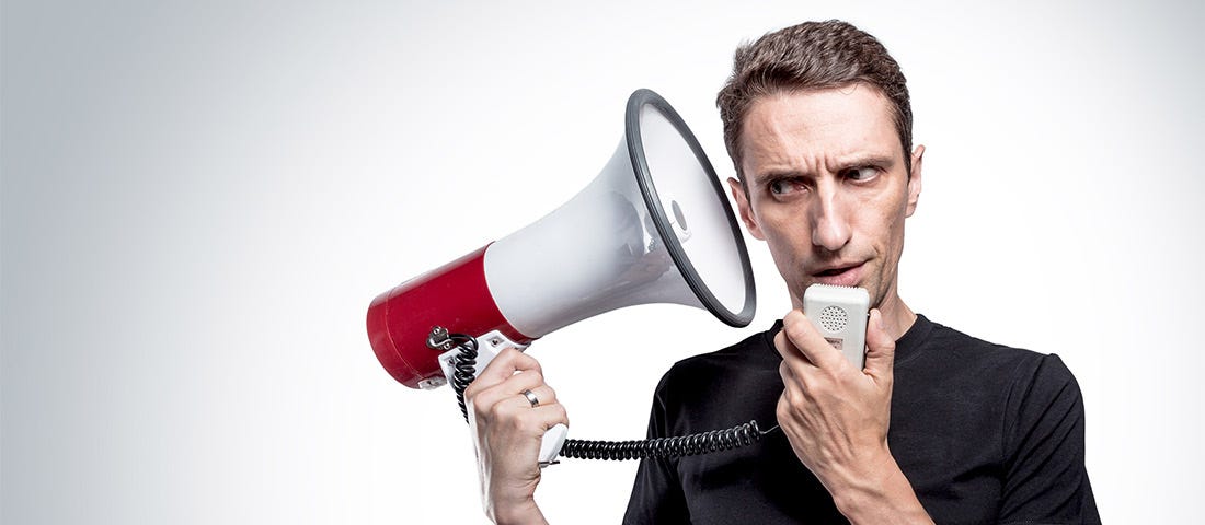 Man talking to himself through a bullhorn