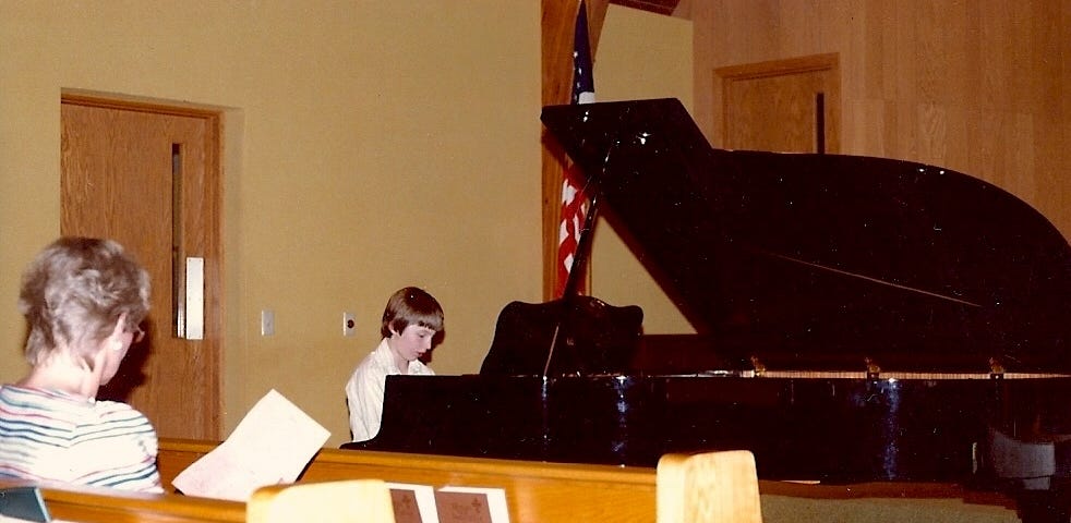 Piano teacher Mrs. Kiffmeyer instructing Gentry Bronson just prior to a piano performance