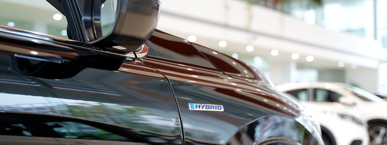 IMAGE: A black hybrid car sitting in a car dealer