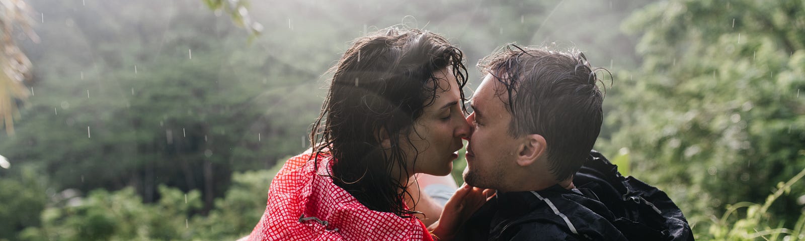 A couple lovingly embraces in a rainstorm.